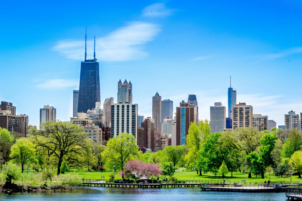 Home Vibrant Chicago skyline featuring the John Hancock Center and lush park foreground.