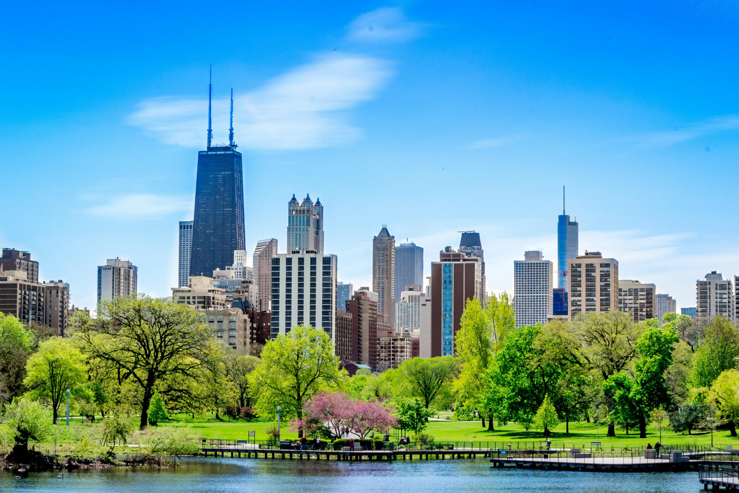 Vibrant Chicago skyline featuring the John Hancock Center and lush park foreground.