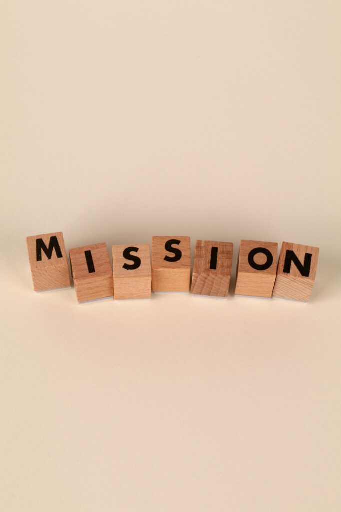 Home Wooden blocks with letters spelling 'Mission' on a soft neutral background, ideal for business themes.