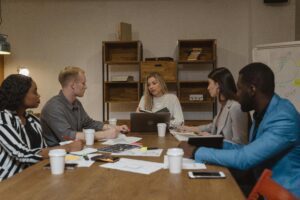 PAG Committee Meeting Business team discussing strategies in a modern office setting, focusing on collaboration.